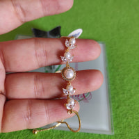 Pulsa fina en oro laminado con acero inoxidable Y perlas